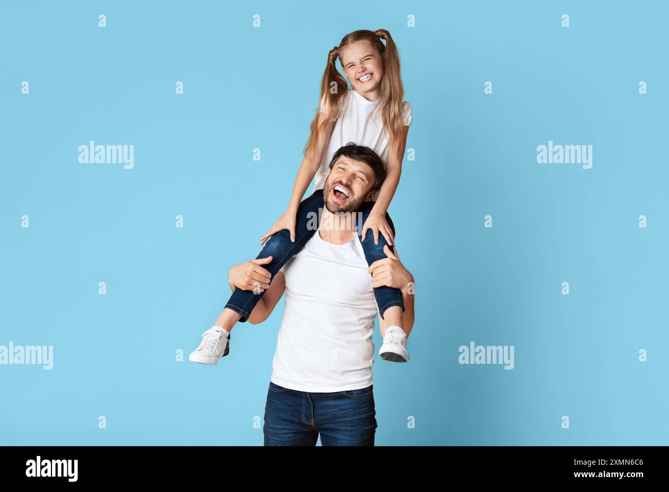 Happy Father And Daughter Having Fun Together On Blue Background Stock Photo
