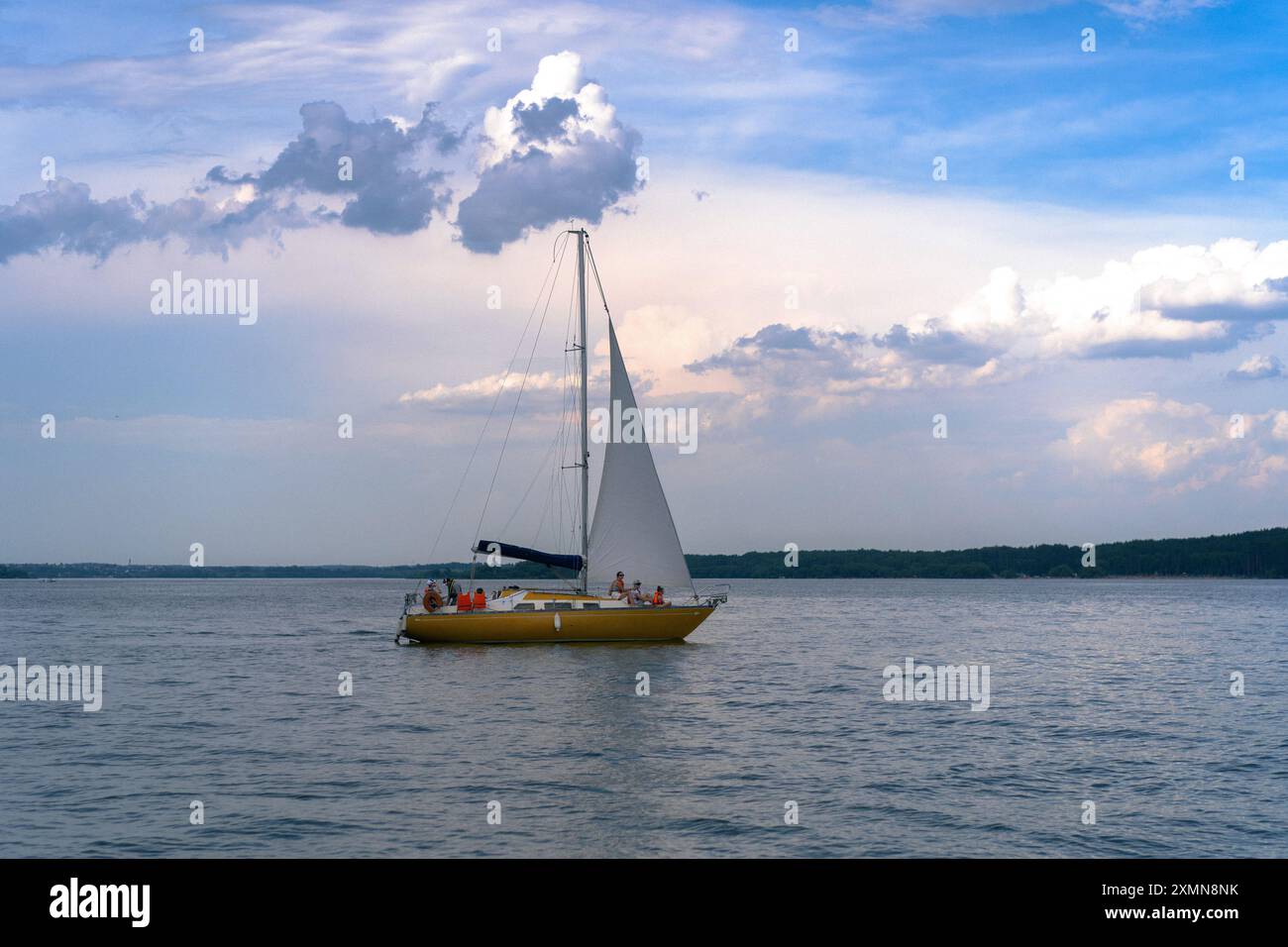 Sailboat sailing on a calm lake on a beautiful day Stock Photo - Alamy