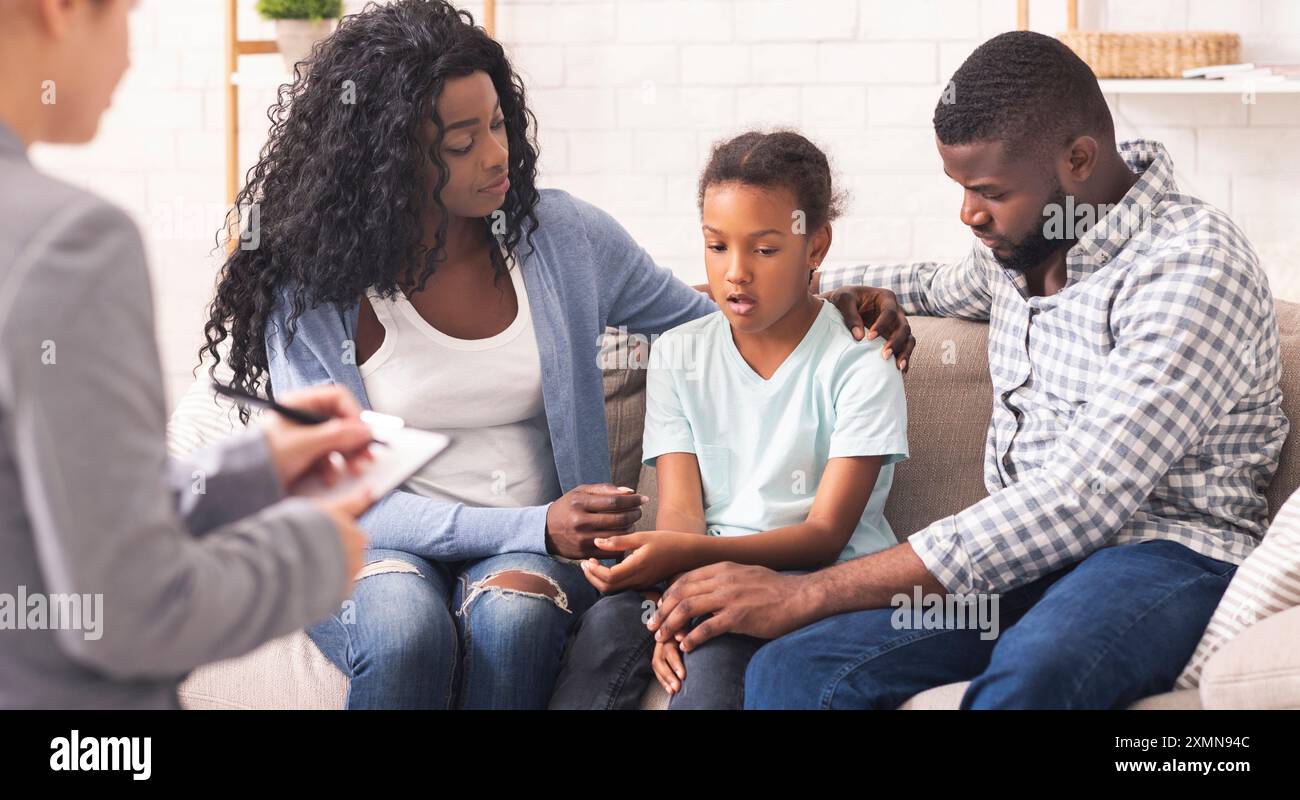 Little black girl and her parents at psychologist consultation Stock ...