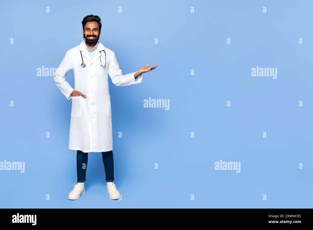 Smiling Doctor Gesturing With Hand in Studio Setting Stock Photo