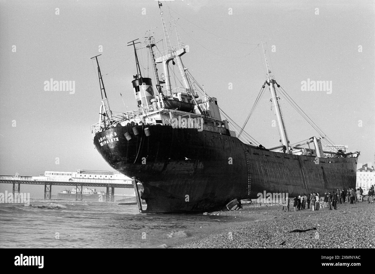 A rare shipwreck on Brighton Beach, the Athina B briefly became a huge tourist attraction after she suffered an engine failure as she tried to enter Shoreham Harbour during a fierce storm. She drifted east, missed the Brighton Palace Pier (seen in background here) by a whisker and beached with such force it took almost a month for salvage workers to unload her and tow her off. She left on 21 February 1980, cheered by a large crowd and has now been scrapped. This picture was taken the morning after she ran ashore.Picture by Roger Bamber Stock Photo