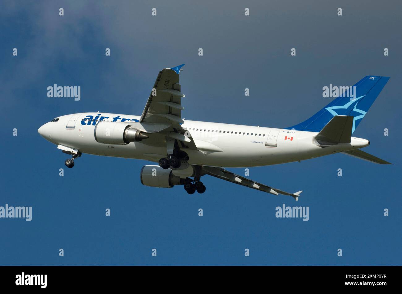 Picture by RogerBamber : 04 October 2008 : The wheels retract into the aircraft fuselage as a 'Air Transat' Airbus A310  Jet Airplane takes off from Gatwick airport, West Sussex, enroute to Canada. Stock Photo