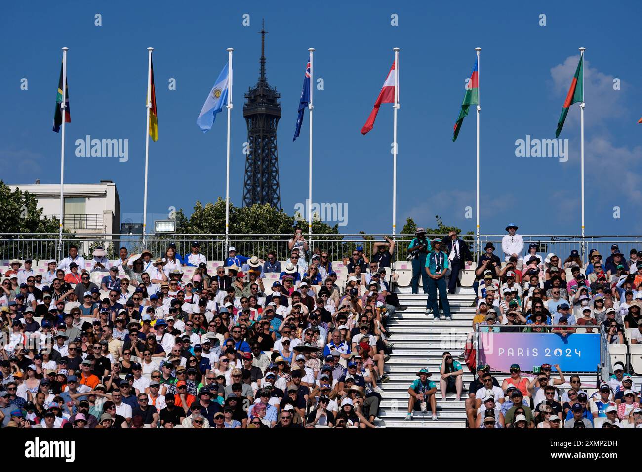 The Eiffel Tower is seen in the background as spectators watch the men ...