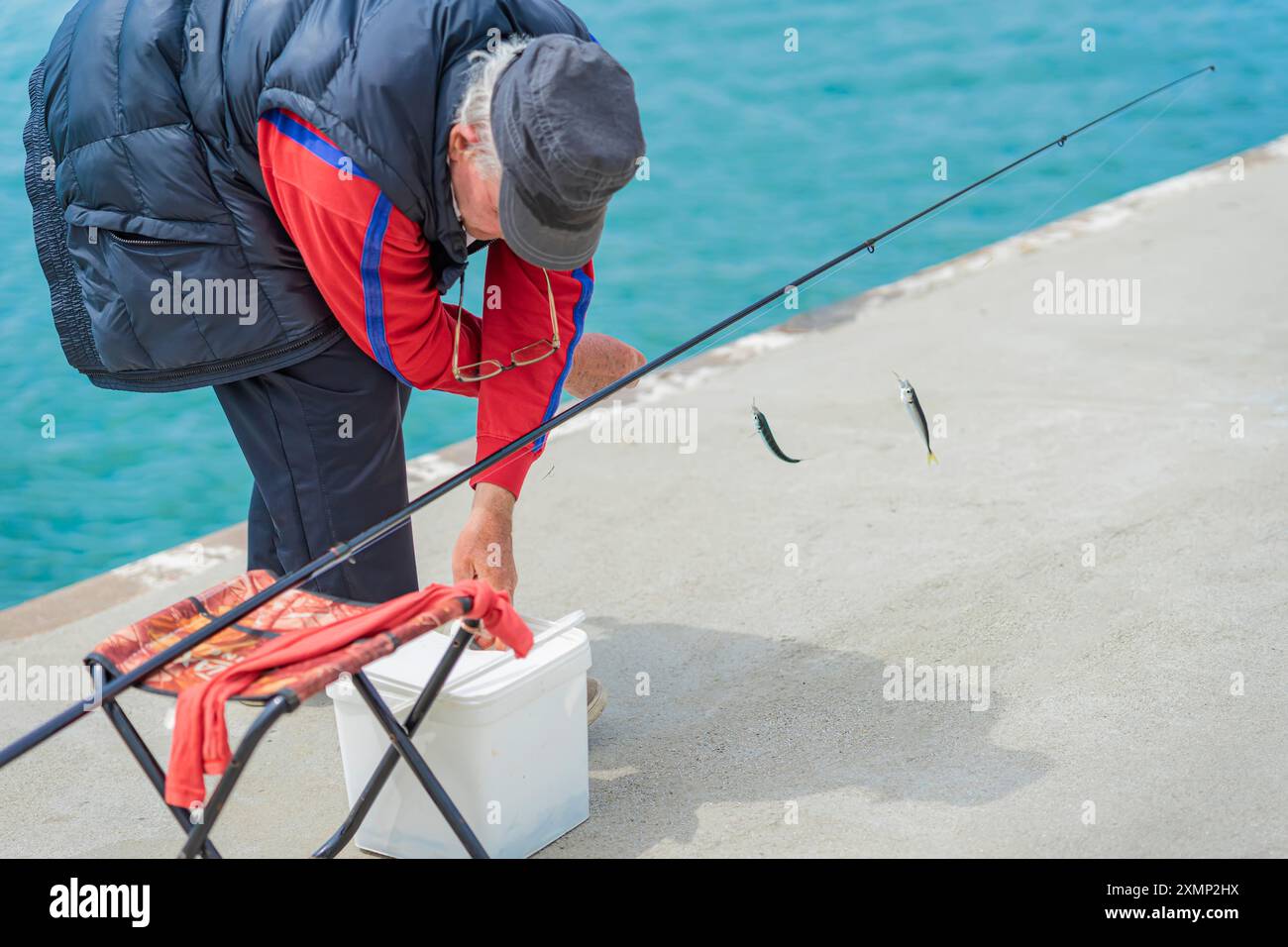 Man removes hook caught fish hi-res stock photography and images - Alamy