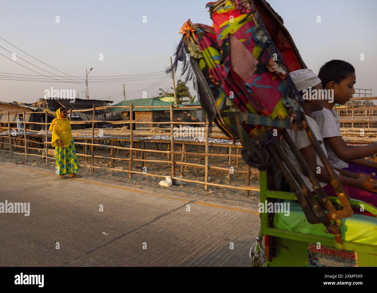 Rickshaw passing in front of fish drying in the sun, Chittagong ...