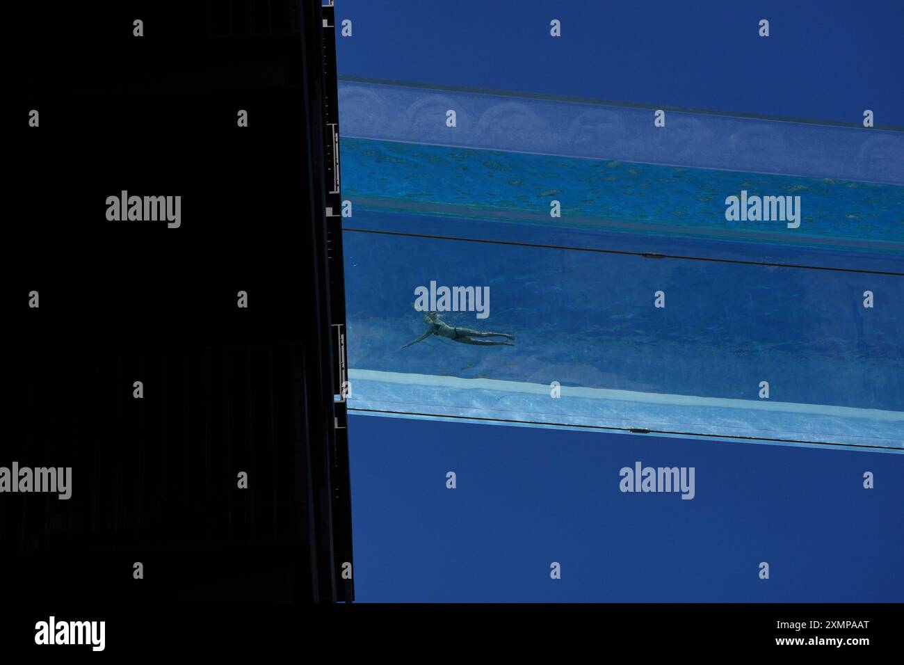 A swimmer in the Sky Pool, a transparent swimming pool suspended 35 ...