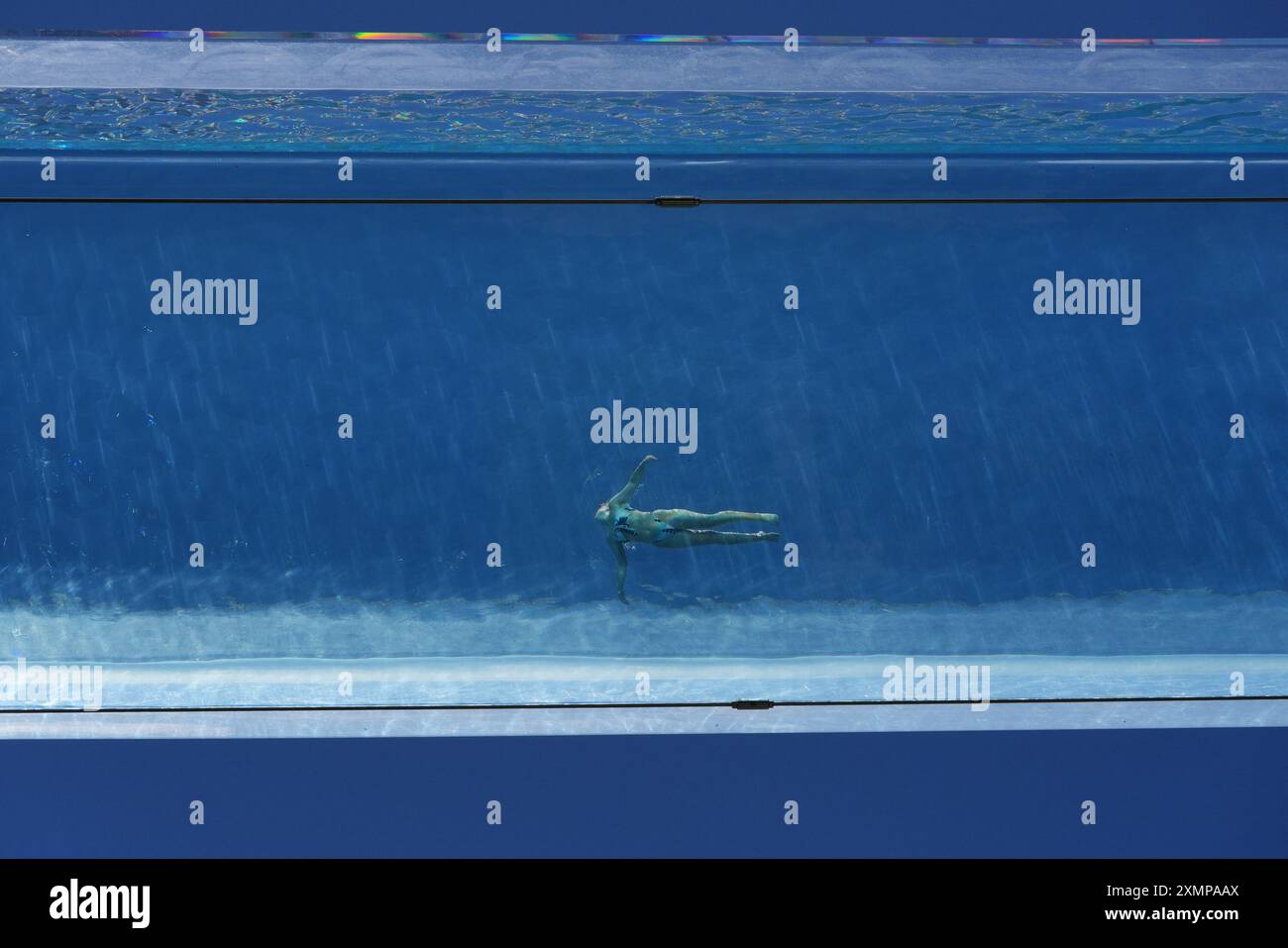 A swimmer in the Sky Pool, a transparent swimming pool suspended 35 ...