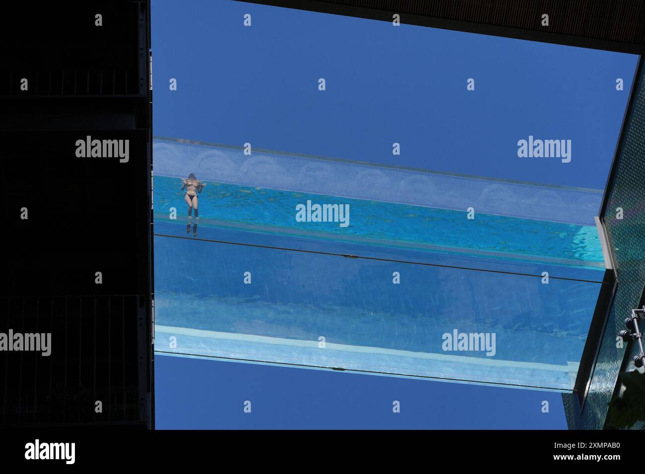 A swimmer in the Sky Pool, a transparent swimming pool suspended 35 ...