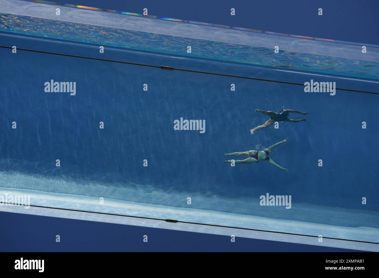 Swimmers in the Sky Pool, a transparent swimming pool suspended 35 ...