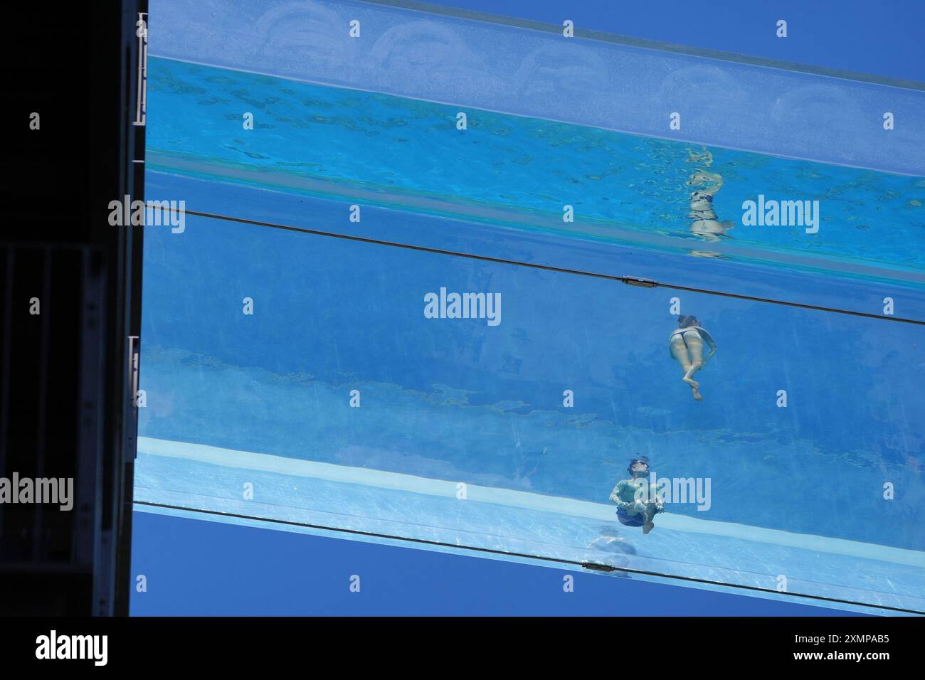 Swimmers in the Sky Pool, a transparent swimming pool suspended 35 ...