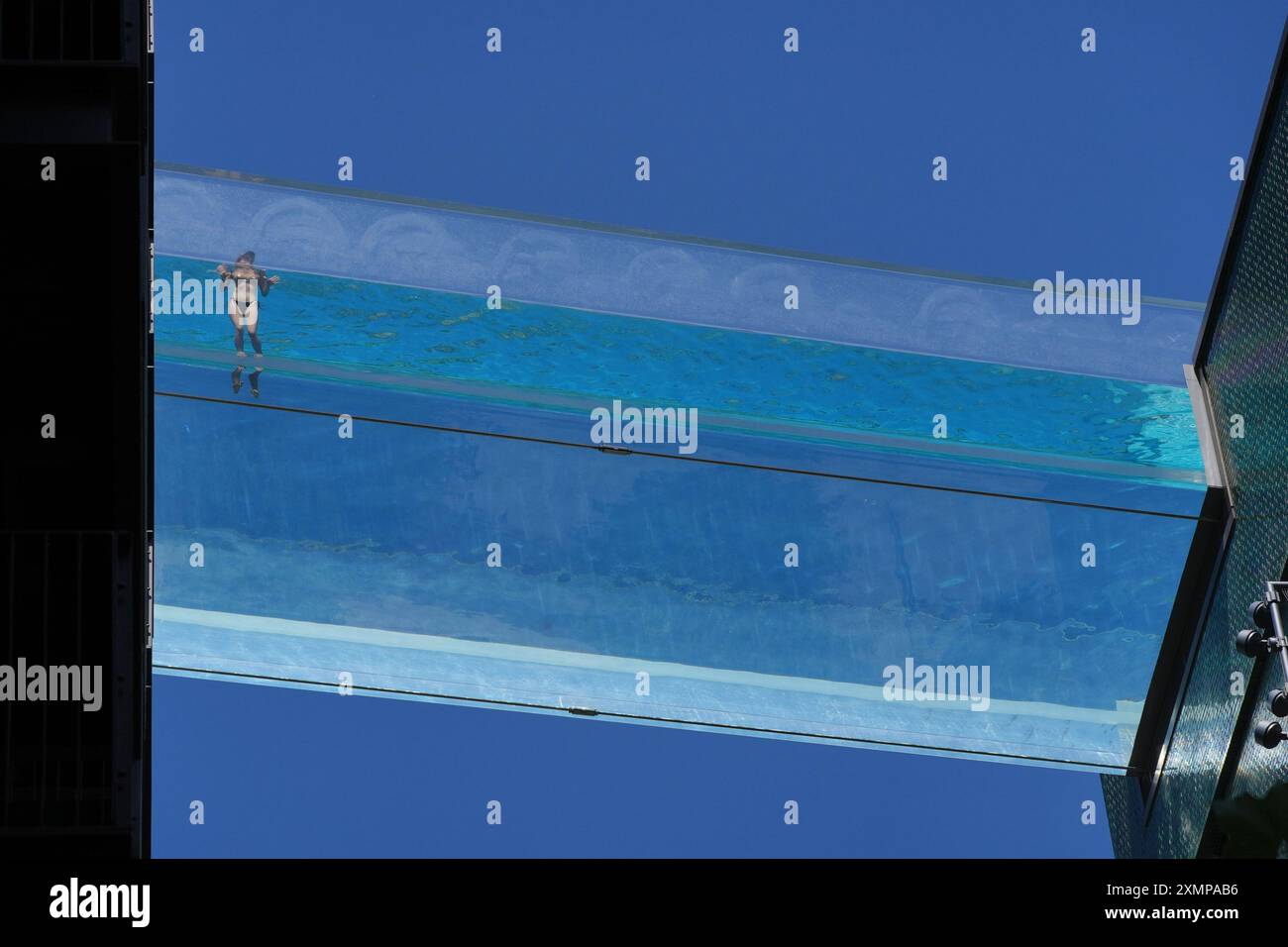 A swimmer in the Sky Pool, a transparent swimming pool suspended 35 ...