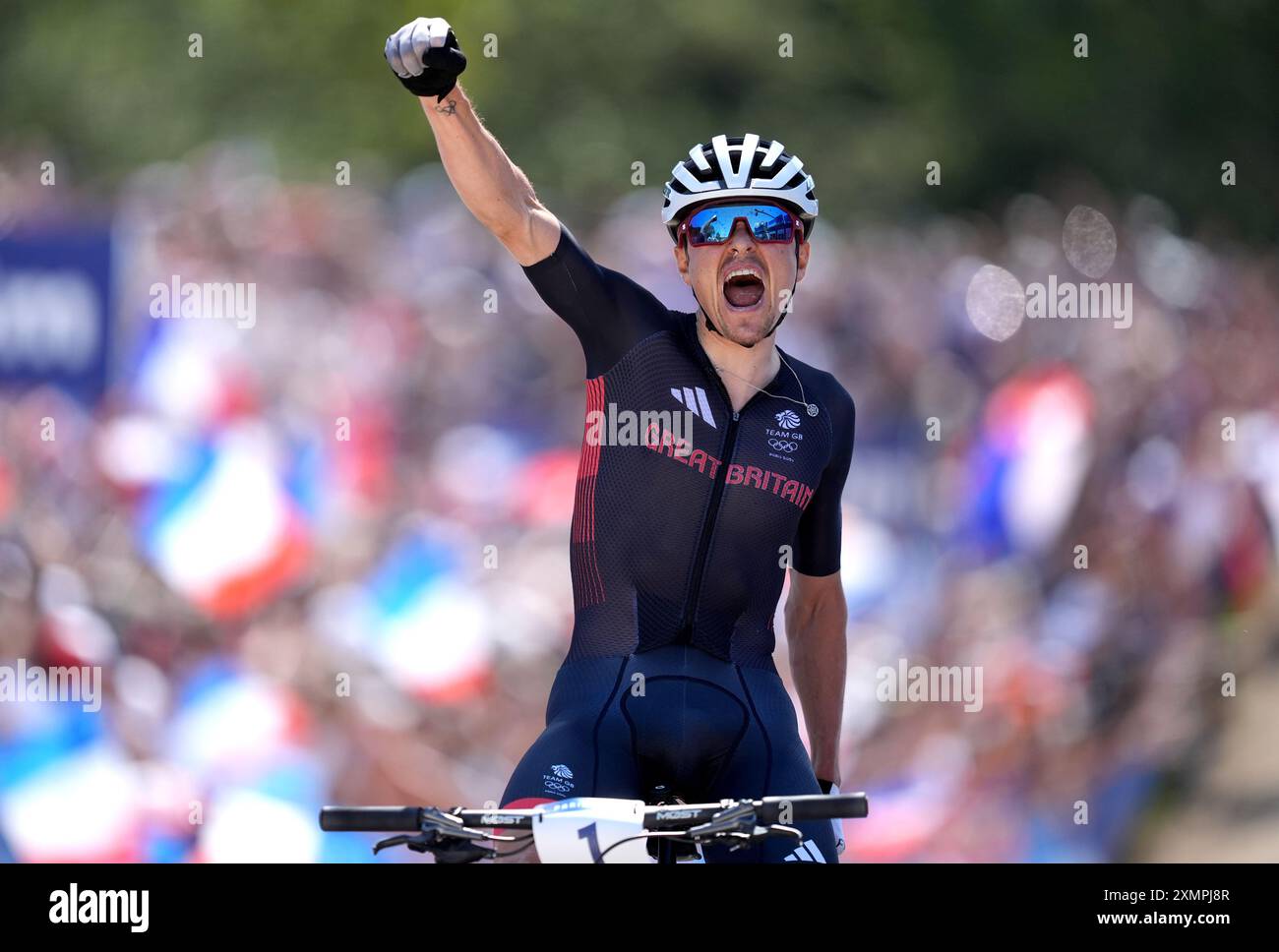 Great Britain's Tom Pidcock crosses the line to win gold during the Men