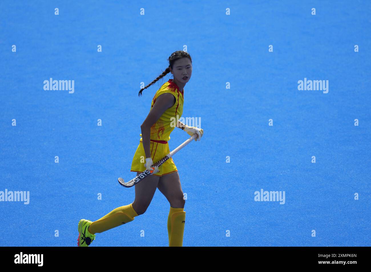 China's Li Hong runs during the women's Group A field hockey match ...