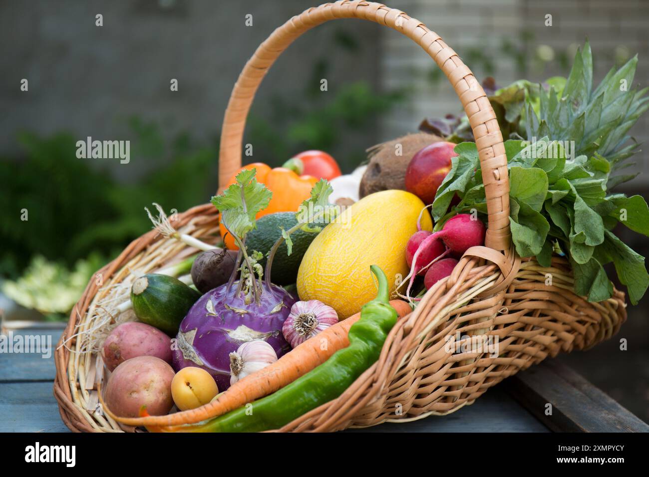 A large wicker basket with various fruits and vegetables. Concept of ...