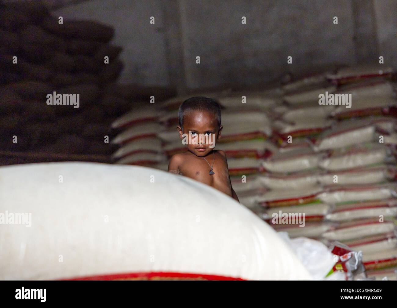 Bangladeshi boy working in a rice warehouse, Chittagong Division ...