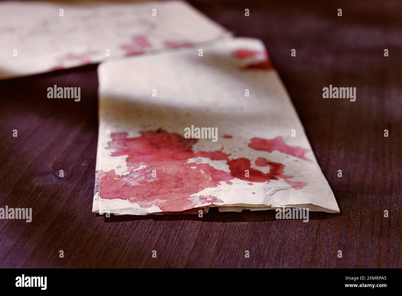 Sheet of letter with blood drops on wooden table , mystery and damage ...
