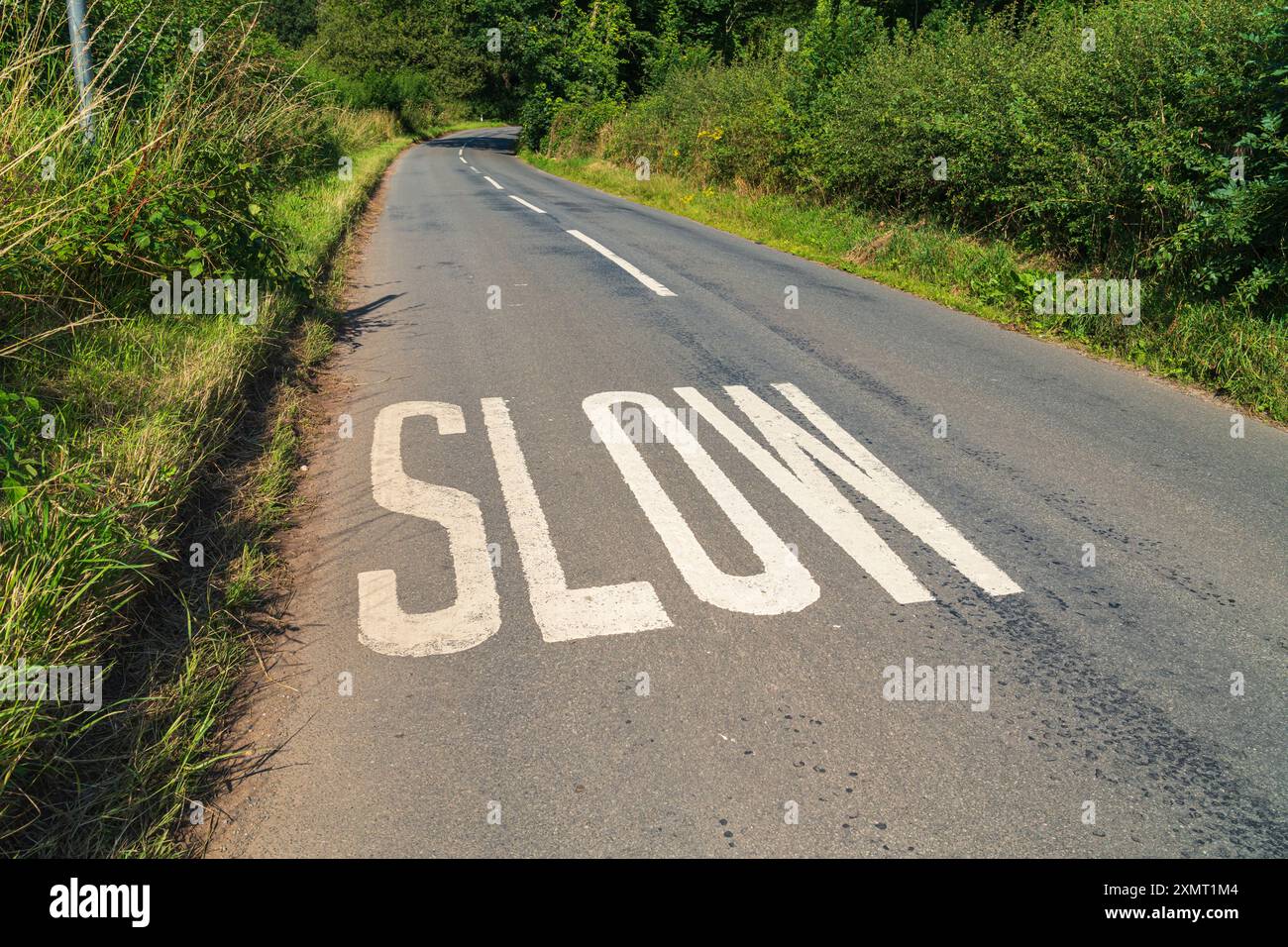 Slow sign painted on the Road, UK Road Sign Speed street sign Stock Photo