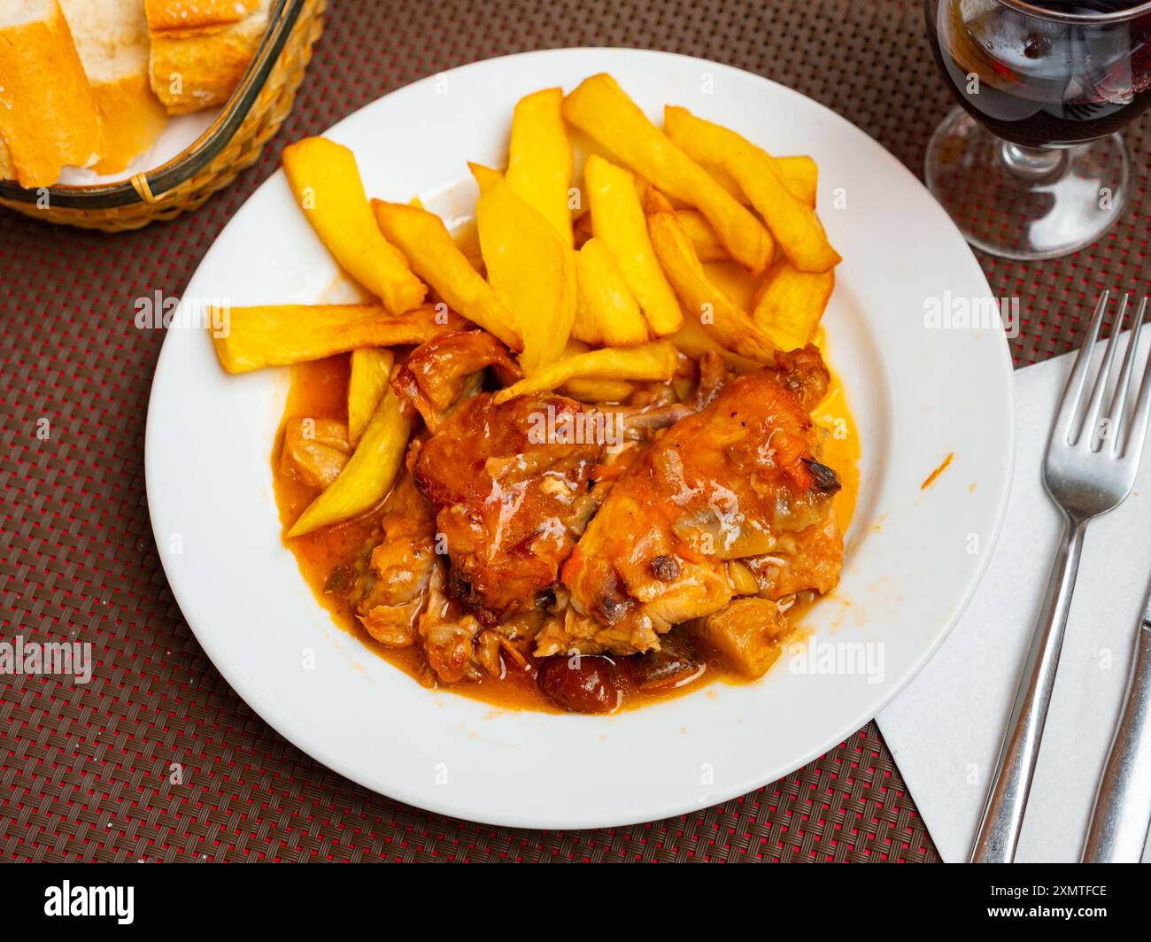 Braised rabbit served with potato garnish Stock Photo