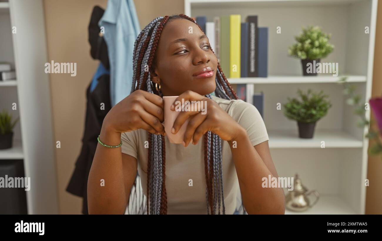 A contemplative african american woman with braids enjoys a coffee in a ...