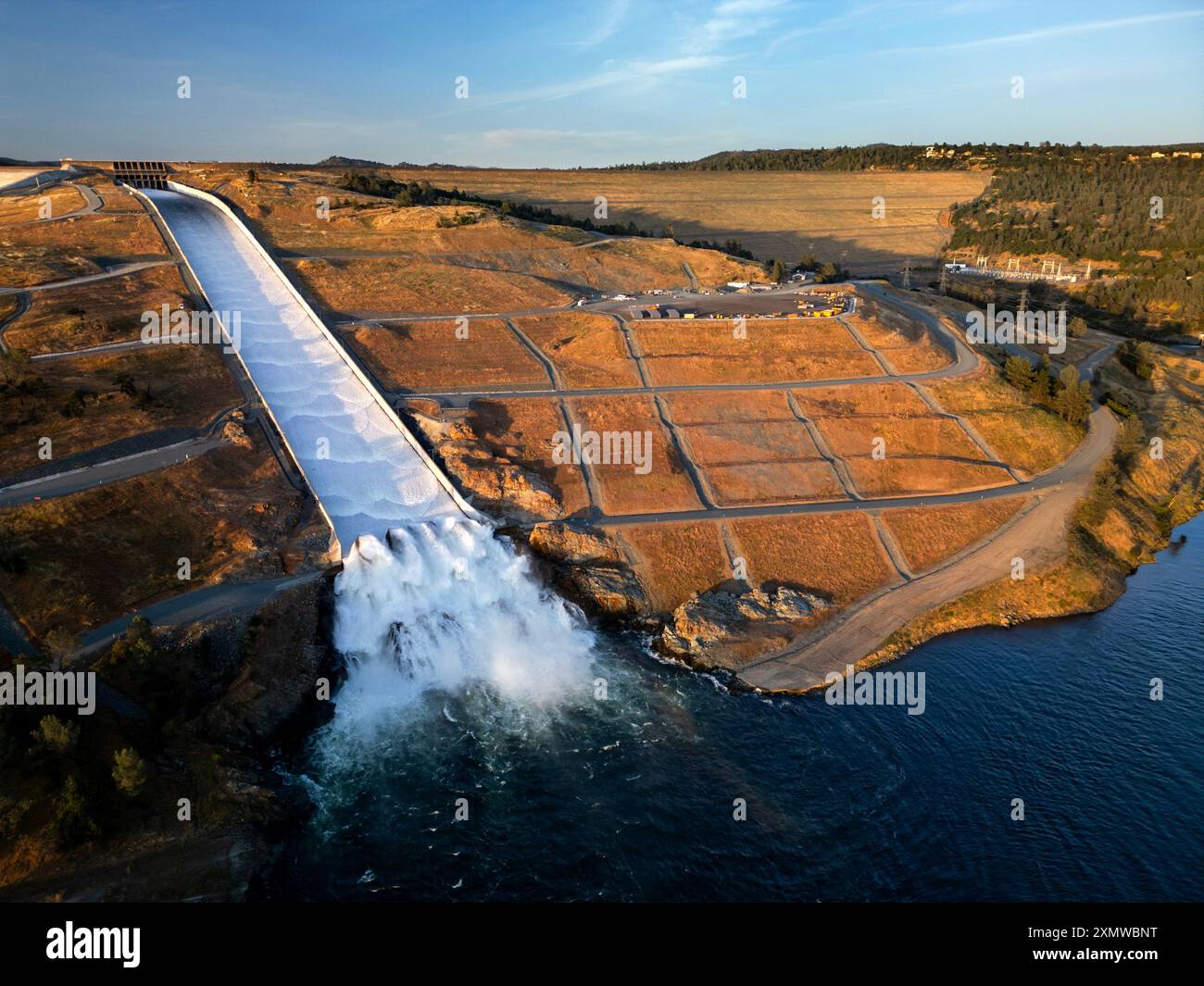 Aerial view of the Lake Oroville Dam with the new spillway in action entering the Feather River in northern California Stock Photo