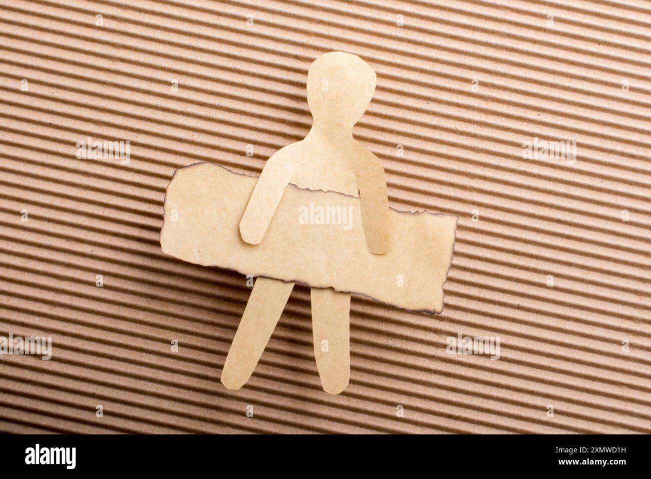 Paper man shape holding burnt note paper in hand Stock Photo