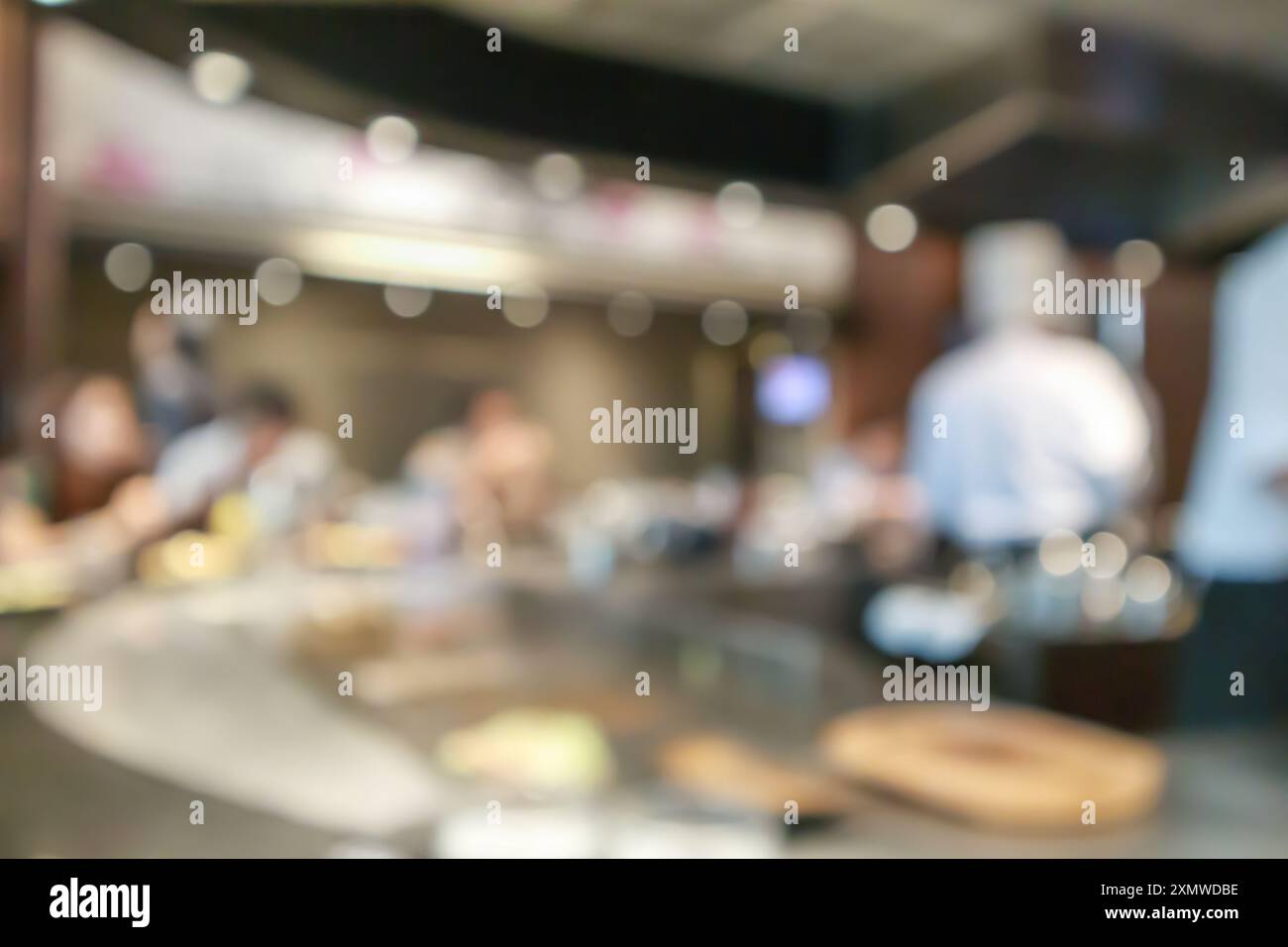 Chef cooking in restaurant kitchen abstract blurred defocused ...