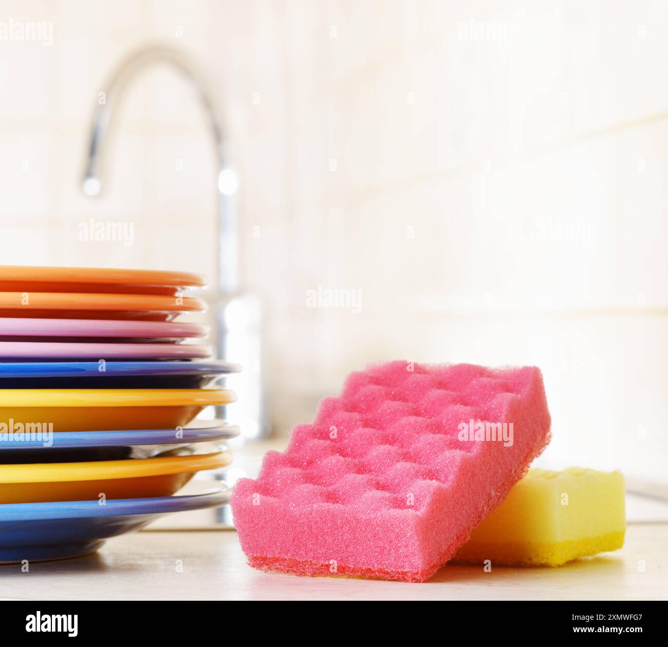 Several plates and a kitchen sponge. Dishwashing concept Stock Photo