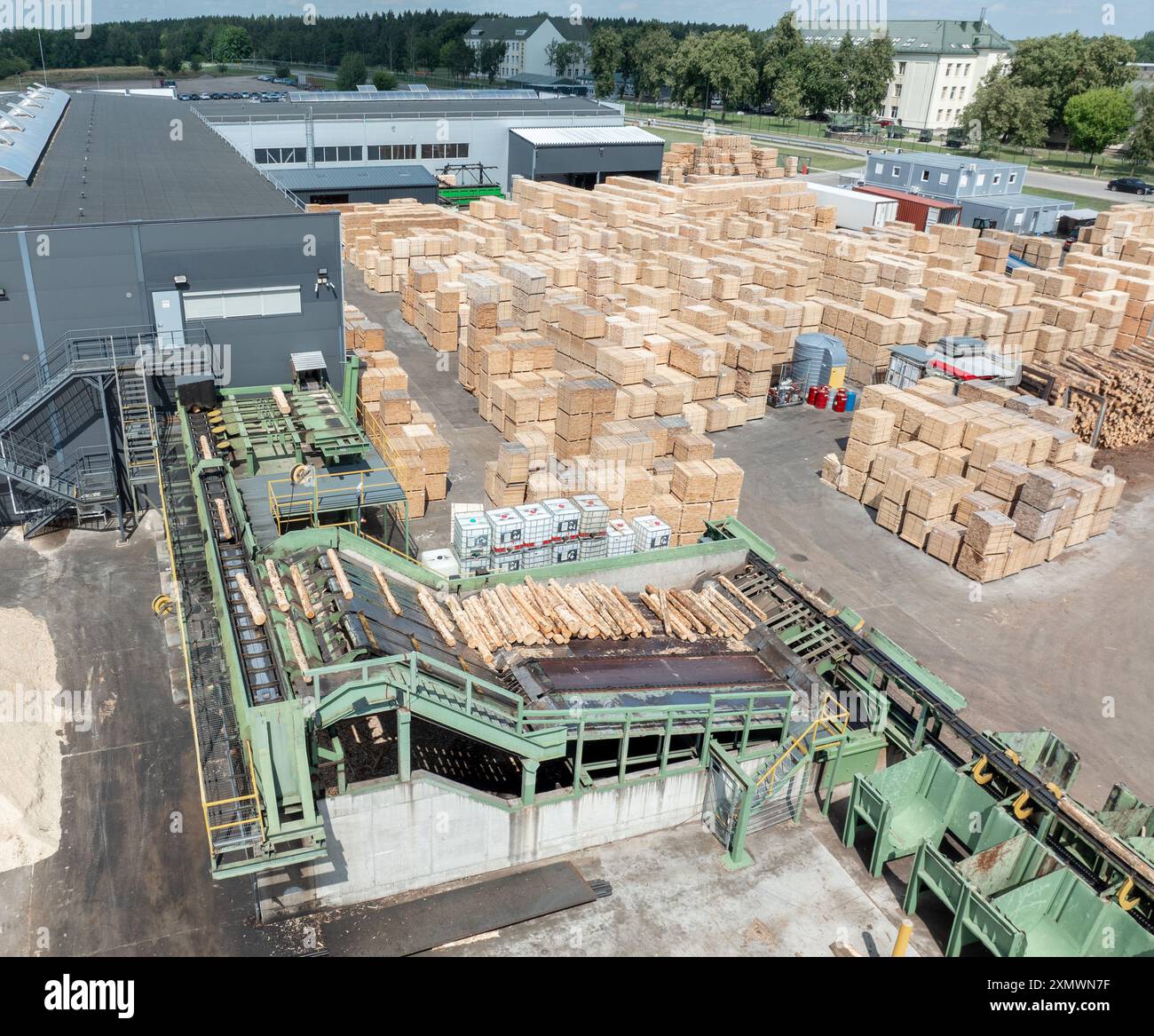 Wood sawmill, machinery for processing wood. Processing plant. A worker ...