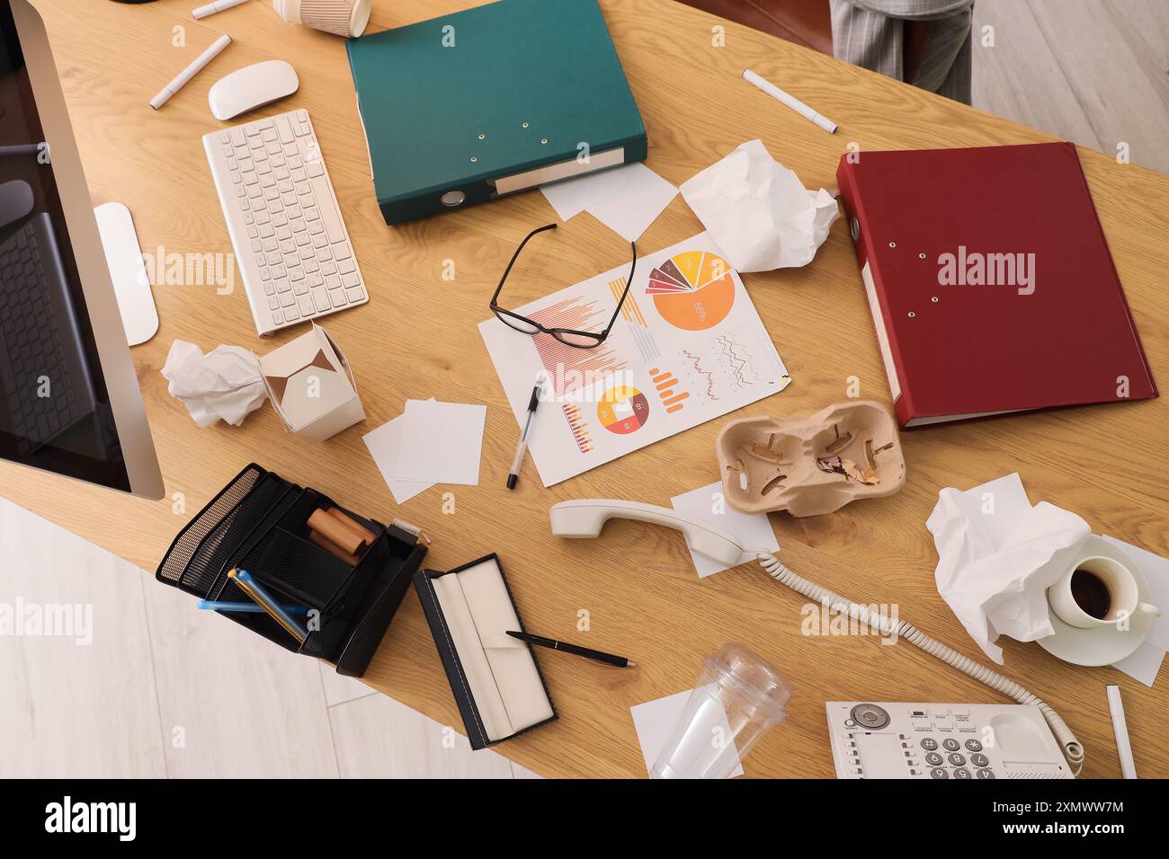 Folders with garbage on desk in messy office, top view Stock Photo