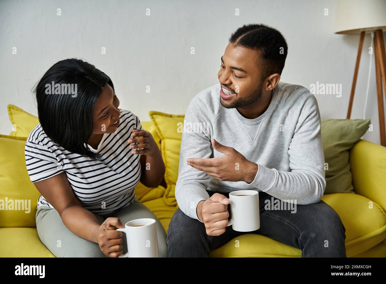 An African American couple enjoys a cozy evening at home, sharing a ...