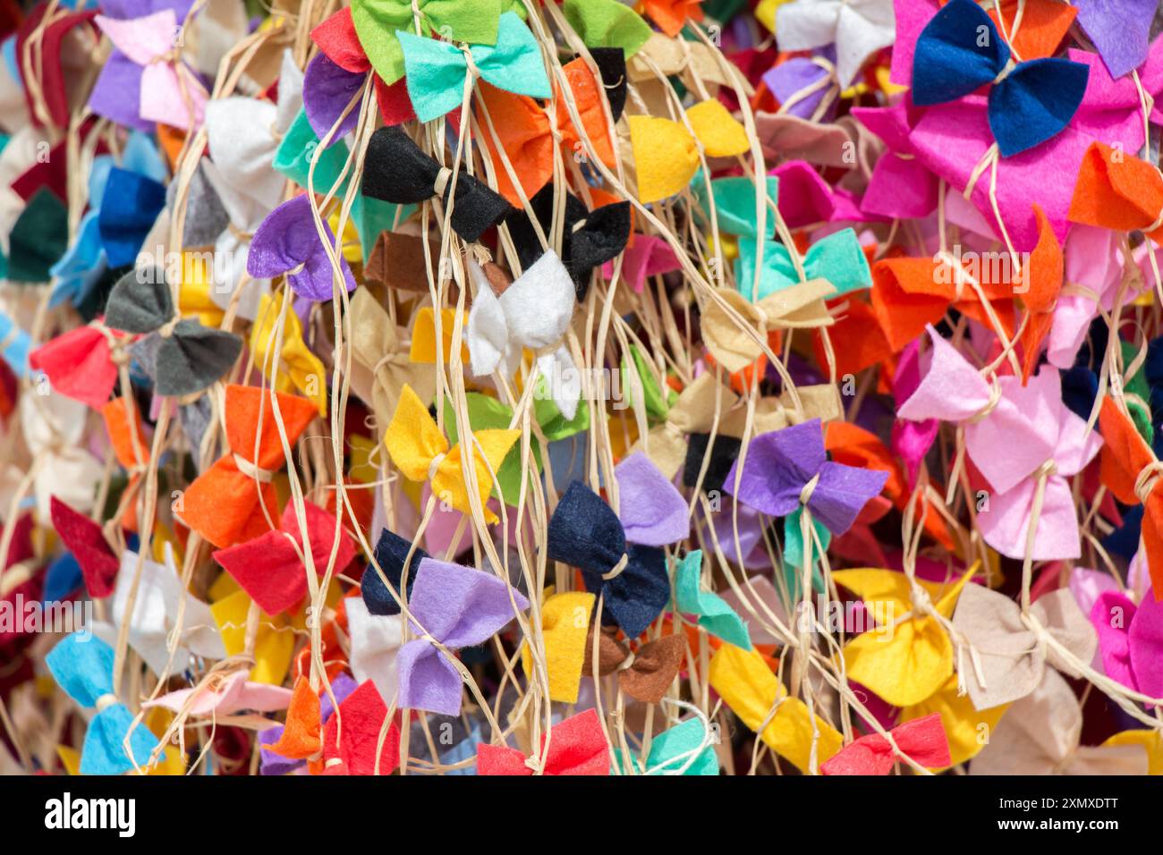 Collection of colored bows and ribbons on threads Stock Photo - Alamy