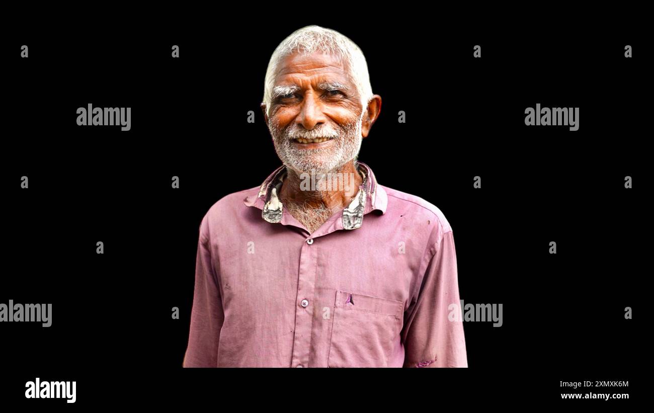 Happy Old Indian senior citizen. Portrait of a rural Indian farmer posing at black background. Stock Photo