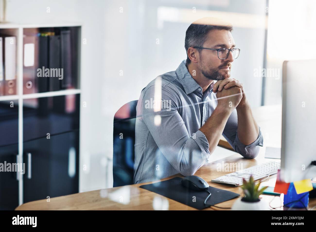 Business man, thinking and planning on computer for information technology or programming solution. Programmer or online developer reading on desktop Stock Photo