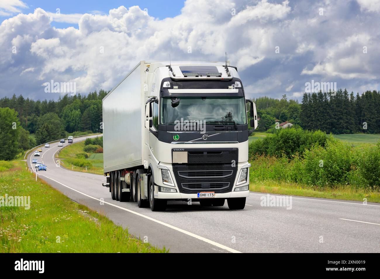 White Volvo FH truck semi trailer transports goods in highway 