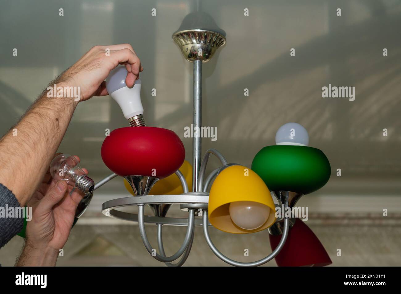 we change the incandescent lamp to an LED one. Stock Photo