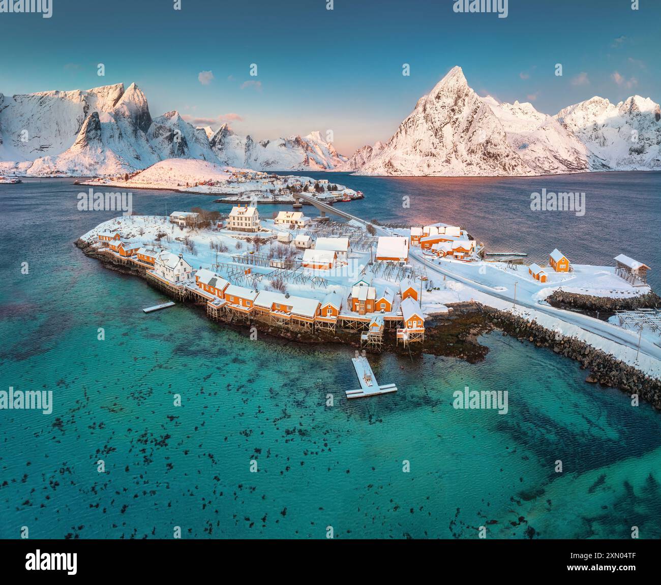 Lofoten islands beautiful nature landscape in Norway and fishing town with scenic yellow rorbu houses of Sakrisoy, Reine Stock Photo