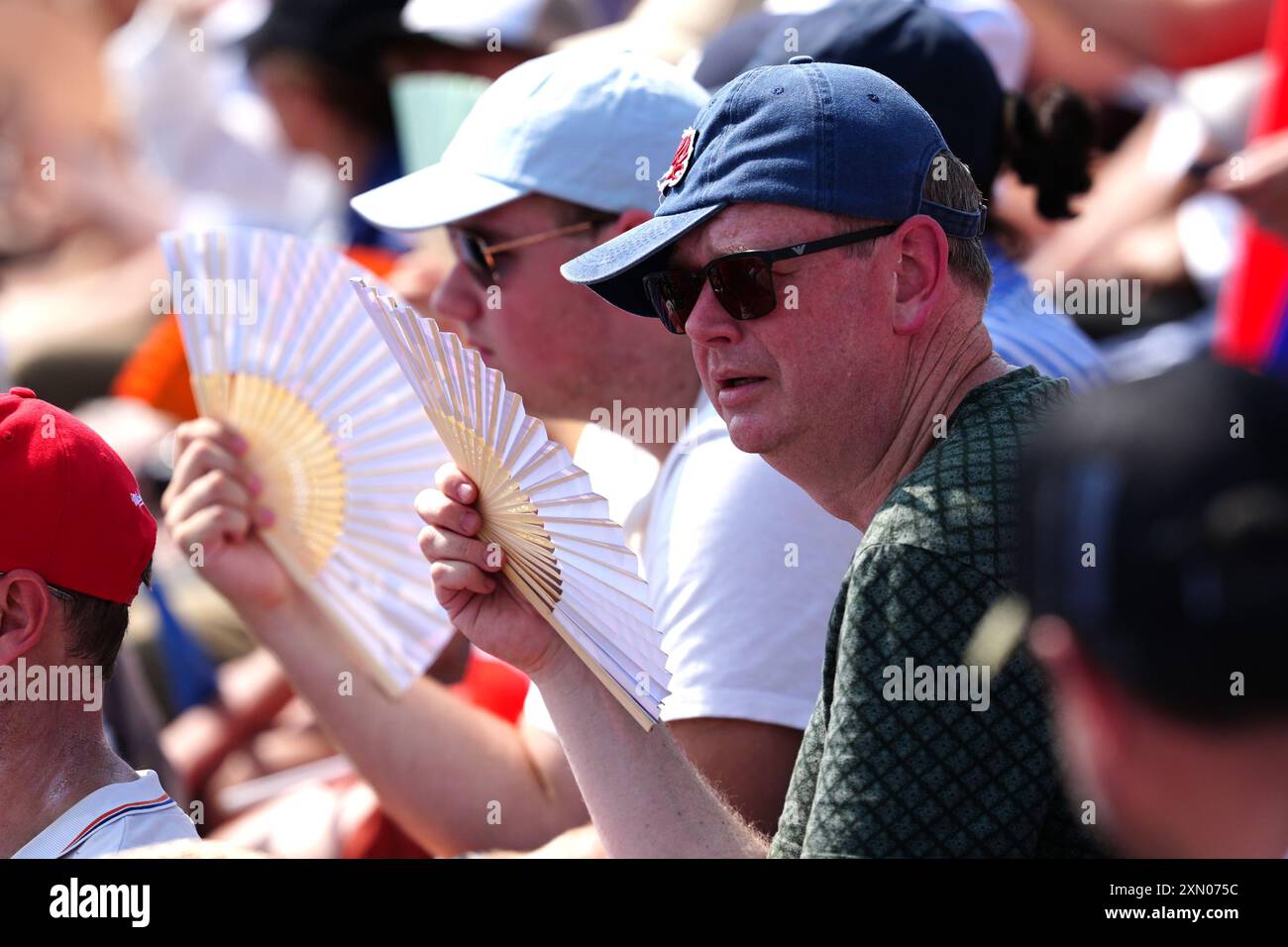 A spectator fans himself during the Men's Park Qualification at La ...