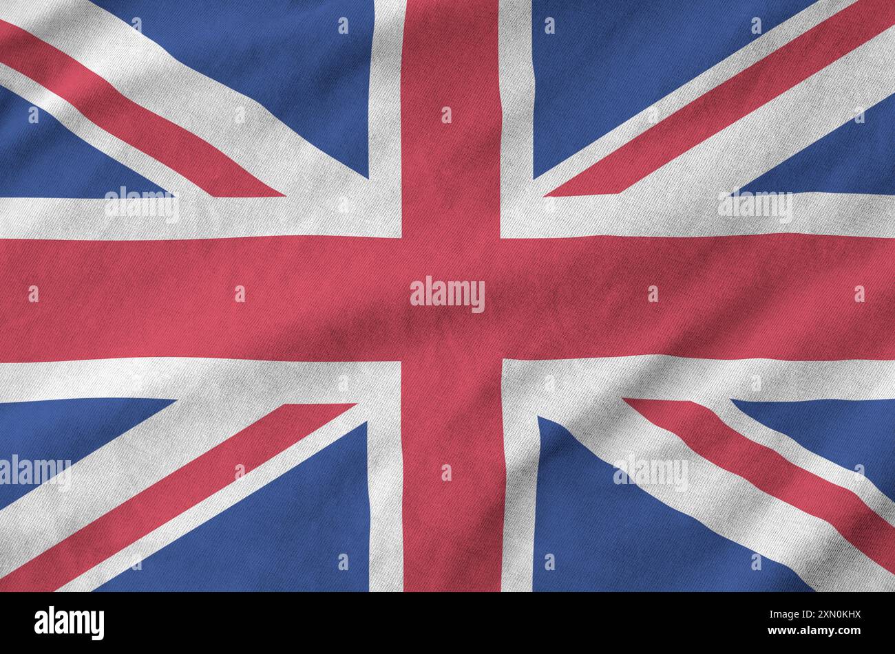 Great britain flag depicted on folded wavy fabric of old cloth close up ...
