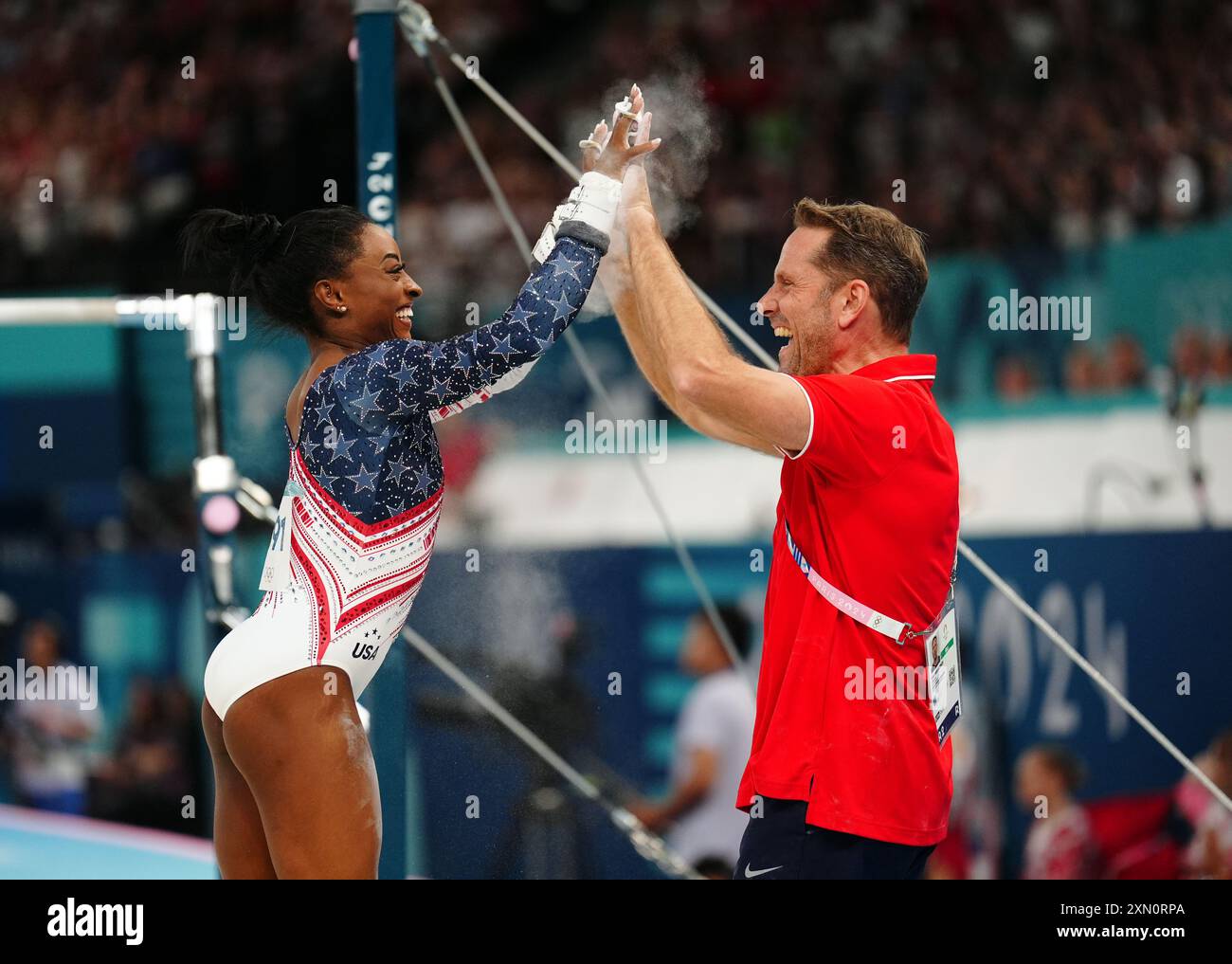 USA's Simone Biles with coach Laurent Landi (right) during the artistic gymnastics, women's team final, at Bercy Arena on the fourth day of the 2024 Paris Olympic Games in France. Picture date: Tuesday July 30, 2024. Stock Photo