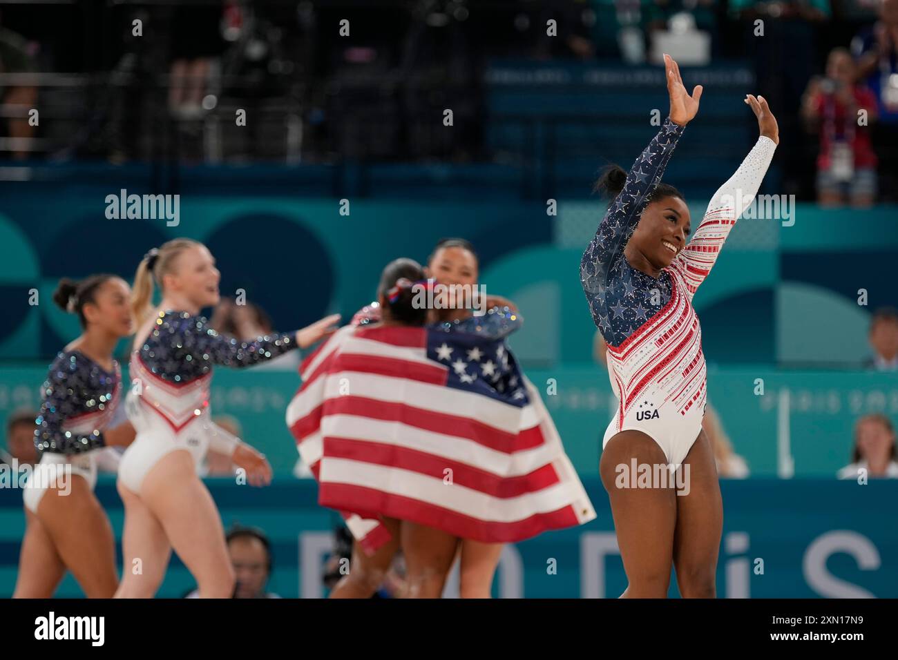 Simone Biles, right, and Team USA celebrate after winning the gold ...