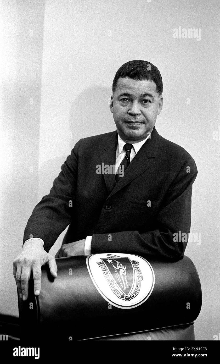 Senator edward brooke standing behind chair decorated with great seal
