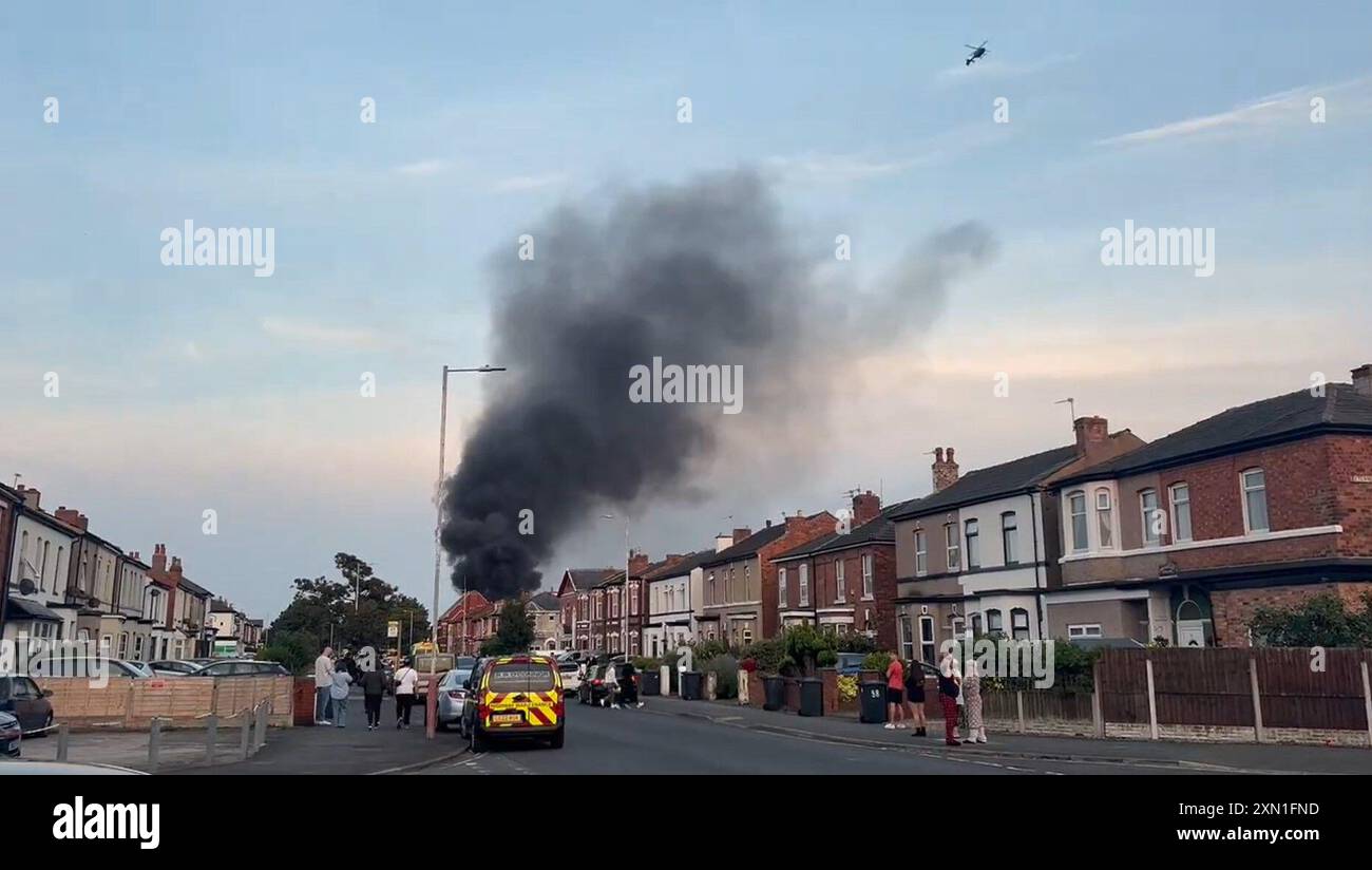 Ferocious Police A police van set alight as trouble flares during a protest in Southport ...