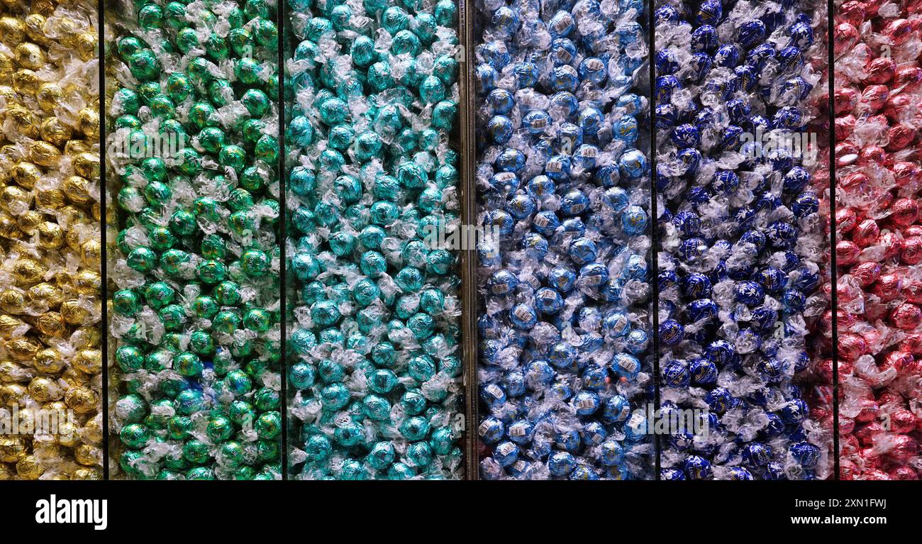 Bin with colorful wrapped candies Stock Photo