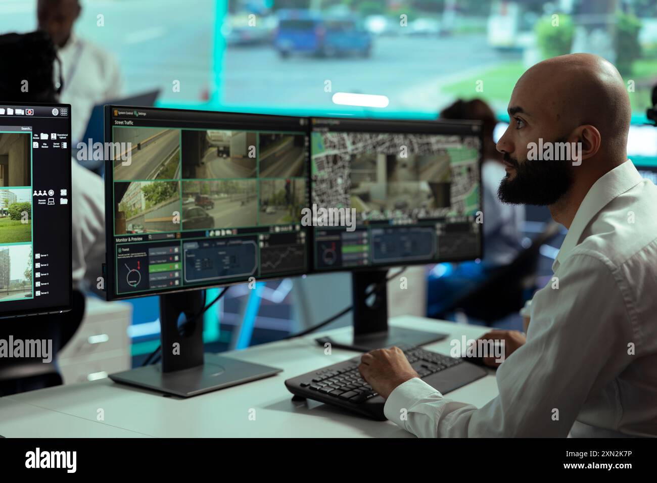 Middle eastern employee monitoring traffic surveillance footage on ...