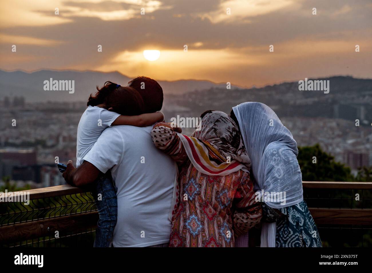 July 30, 2024, Barcelona, Spain: A family watches the sunset from the Montjuic hill on a day when Barcelona reached 40 degrees Celsius, the highest temperature ever recorded in the Catalan capital. Credit: Jordi Boixareu/Alamy Life News Stock Photo