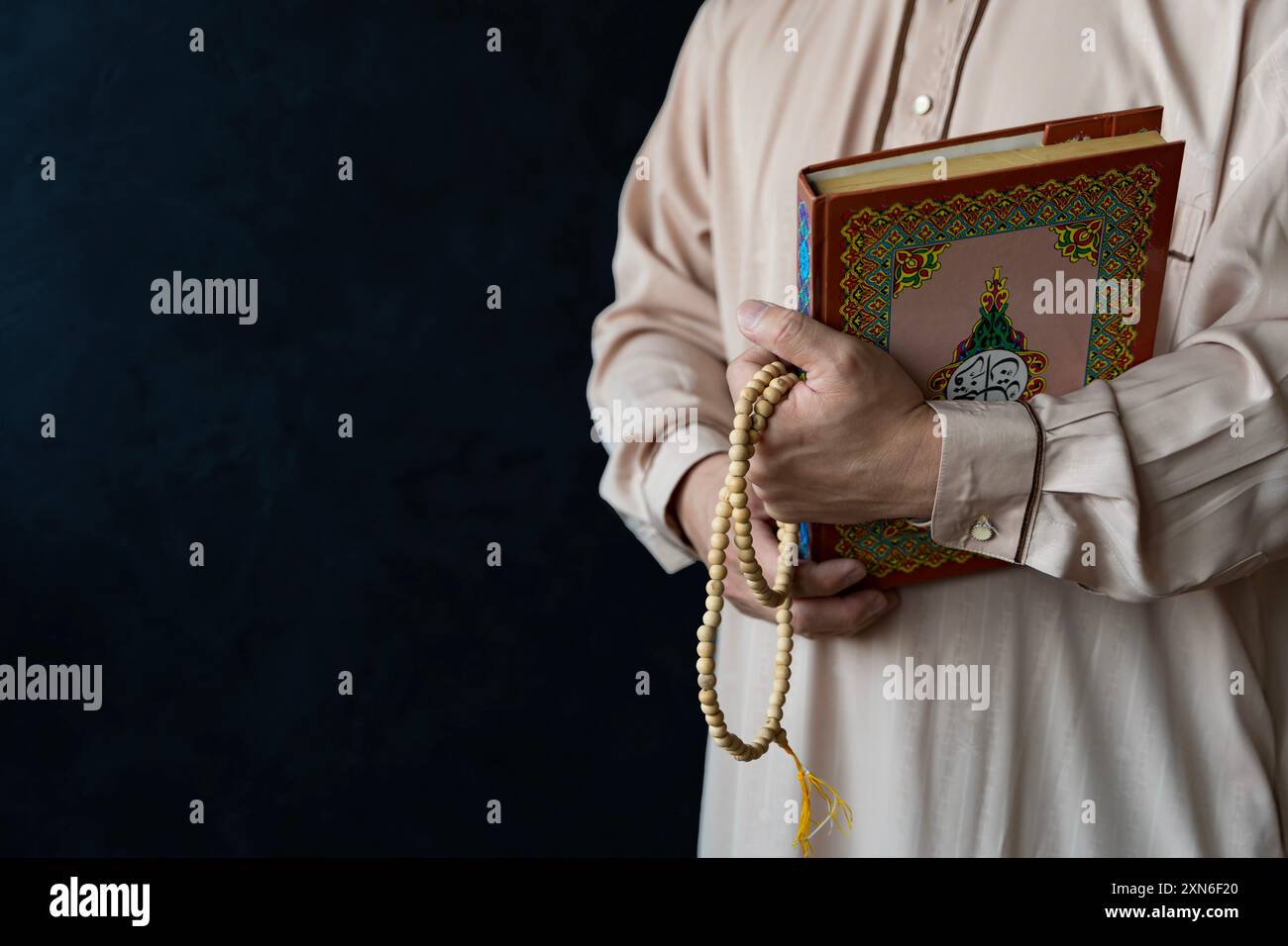 Muslim man is reading the quran. Muslim man praying in mosque for blessings in a sunlit old Islamic of mosque. Stock Photo