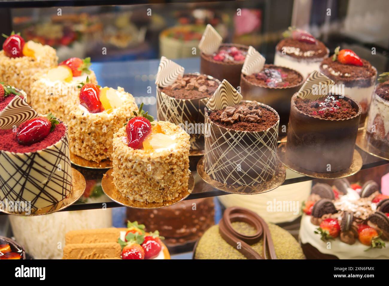 An array of pastries and eclairs are presented in the bakery display ...