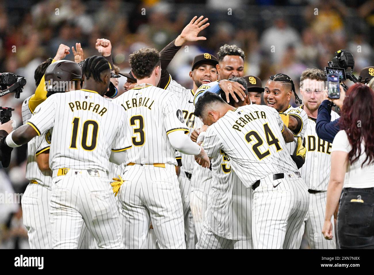 San Diego Padres players congratulate Donovan Solano (39) after he hit a  walk-off single during the 10th inning of a baseball game against the Los  Angeles Dodgers, Tuesday, July 30, 2024, in