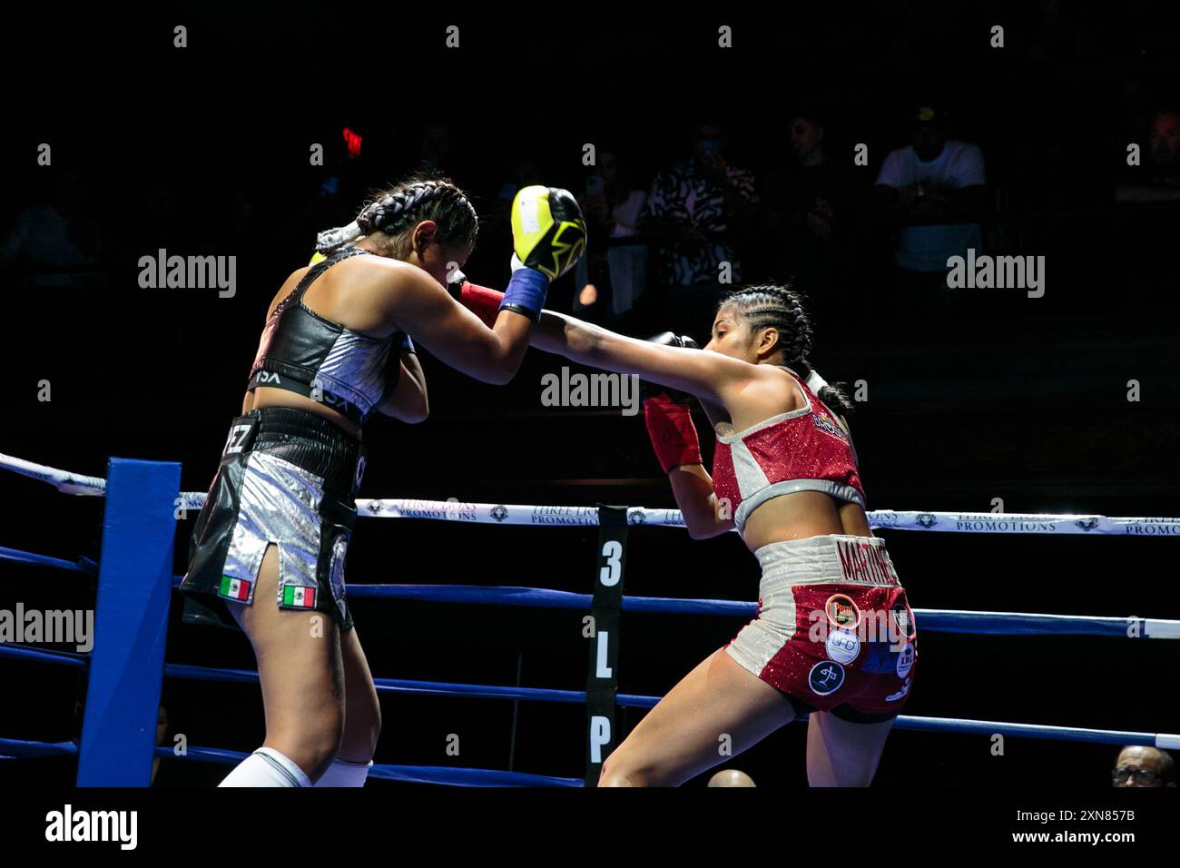 Meilyn Martinez (red trunks) and Shadem Aguilar face off during a ...