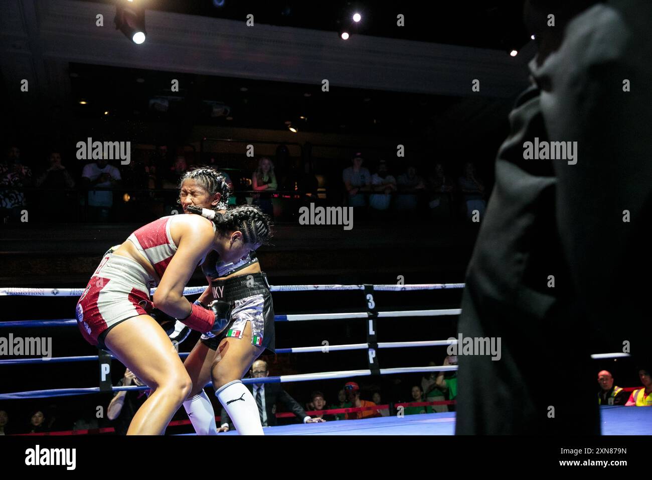 Meilyn Martinez (red trunks) and Shadem Aguilar face off during a ...